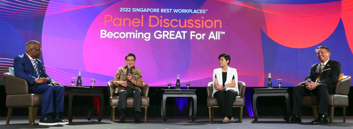 Four panelists on stage in front of "2022 Singapore Best Workplaces™" backdrop.